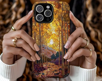 May include: A phone case featuring a stained-glass style forest scene with a warm color palette of gold, brown, and purple. The design includes trees, a sun, and a path, creating a nature-inspired aesthetic.