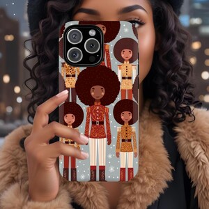 May include: A phone case featuring a repeating pattern of cartoon figures with large afros, wearing military-style uniforms in red, gold, and brown. The background is a light blue with white snowflakes. The case has a camera cutout.