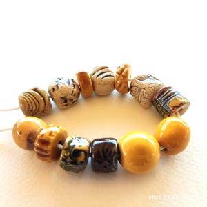 Unique ceramic Beads yellow and white glazed clay pieces worn style different shapes
