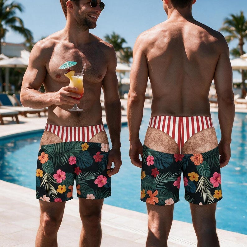 May include: Swim trunks featuring a black base with a colourful tropical floral pattern of pink, yellow, and orange hibiscus flowers and green palm leaves, accented by a red and white vertical striped waistband and a faux-skin cutout design.