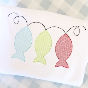 May include: Three embroidered fish in blue, green, and red hanging from a black string. The fish are outlined in black and have a textured pattern.