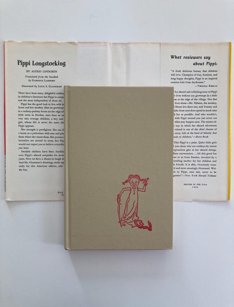 May include: A beige hardcover book titled Pippi Longstocking by Astrid Lindgren, featuring a red line drawing of a girl on the front cover. The book is displayed with its open dust jacket, which contains printed text and reviews about the story.