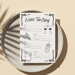 May include: A white wine tasting sheet with black illustrations of wine glasses, grapes, and a wine bottle. The sheet has the words "Wine Tasting" at the top and spaces to record scores and notes.