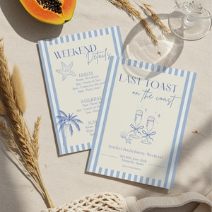 Puede incluir: Dos tarjetas de invitación con rayas azules y texto, una que dice "Weekend Details" y la otra "Last Toast on the Coast". También se ve media papaya, espigas de trigo y un vaso. Las tarjetas son para un fin de semana de despedida de soltera.