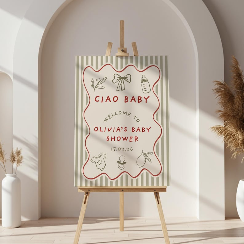May include: A baby shower sign on a wooden easel. The sign has a cream background with vertical stripes and a red wavy border. The text "CIAO BABY" and "WELCOME TO OLIVIA'S BABY SHOWER" are displayed, along with baby-themed illustrations.
