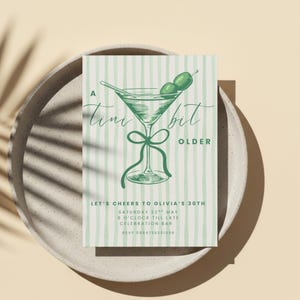 May include: A birthday invitation card with a martini illustration. The card features the text "A tini bit older" and event details. The design includes a green martini glass with olives, set against a striped background.