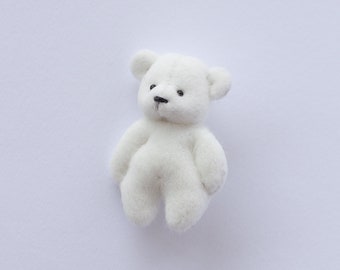 Miniature teddy bear for 1:12 dollhouses. 2" size. Swivel head. White color.
