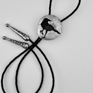 Handmade bolo tie black crow on pewter showing leather braided black cord and tips.