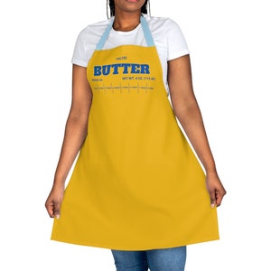 May include: A yellow apron with blue text that reads "SALTED BUTTER NET WT. 4 OZ (113.4G)".
