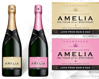 May include: Two champagne bottles with personalized labels. The labels are gold and pink with black text. The text on the labels reads "Congratulations Amelia on your 21st Birthday". The labels also include the date "19th December 2023" and the message "Love from Mum & Dad". The bottles are 750 ml and have an alcohol content of 12%.