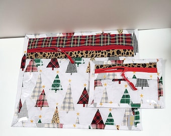 May include: Three Christmas-themed zippered pouches. The largest pouch features a red plaid top, leopard print accent, and a red zipper. The middle pouch has a white background with Christmas trees. The smallest pouch has a similar design.