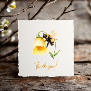 May include: A watercolor illustration of a bumblebee collecting pollen from a yellow flower. The text "Thank you!" is written in orange below the flower.