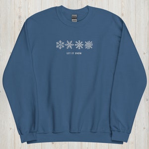 May include: A blue sweatshirt with a white snowflake design and the text "Let It Snow".
