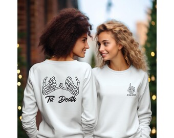 May include: Two white sweatshirts with a skeleton hand design. One sweatshirt has the text "Til Death" and the other has the date "10.24.2023".