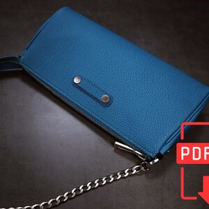 May include: A blue leather chain bag with a zipper closure and silver hardware. The bag has a chain strap and a PDF download icon.