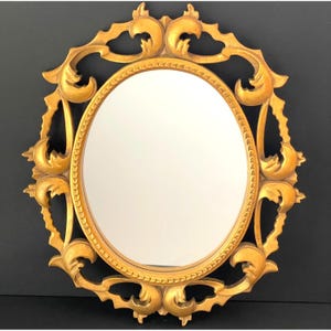 Vintage Hollywood Regency Gold Oval Wall Mirror With Decorative Scroll Frame