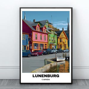 May include: A framed print featuring a colorful street scene in Lunenburg, Canada. The image showcases vibrant buildings in shades of blue, pink, green, and yellow, with cars parked along the street and a small boat in the water. The text "LUNENBURG CANADA" is at the bottom.