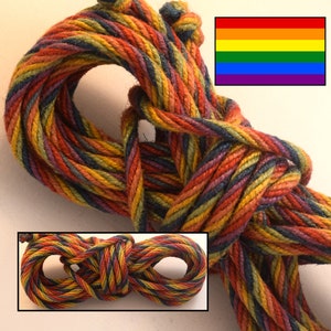 May include: A close-up of a rainbow colored rope, made of natural fibers. The rope is twisted and coiled, showing the different colors of the rainbow. The rope is a popular choice for crafts, macrame, and other projects.