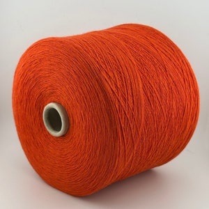 May include: A spool of bright orange yarn.