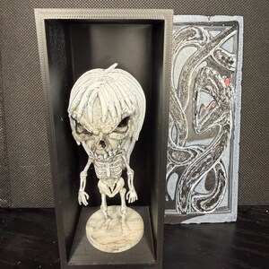 Evil Skeleton figurine with crypt