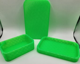 May include: Three bright green plastic containers with a textured surface. The containers are different sizes and shapes.