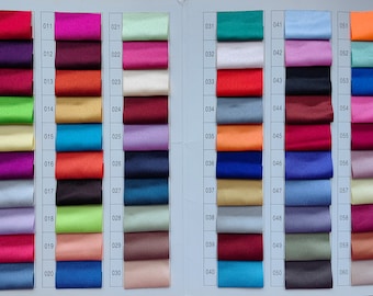 May include: A color chart with 60 fabric swatches. The swatches are arranged in rows of 10, with each row labeled with a number from 001 to 060. The swatches are a variety of colors, including red, blue, green, yellow, orange, purple, pink, brown, and white.