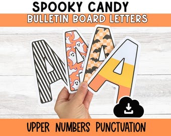 May include: Four letter "A" bulletin board letters with Halloween-themed designs. One letter has black and white stripes, another has orange ghosts, a third has bats, and the last one is candy corn themed. The words "Spooky Candy Bulletin Board Letters" are at the top.