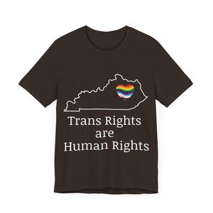 May include: A dark brown t-shirt with a white outline of the state of Kentucky. Inside the outline is a rainbow heart. The text "Trans Rights are Human Rights" is printed in white below the state outline.