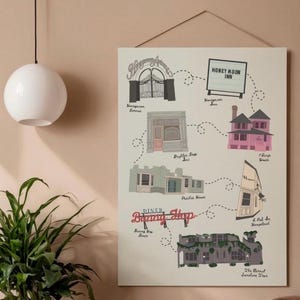 May include: A rectangular wall art print featuring a map of illustrated buildings and locations with dashed lines connecting them. The text includes Honeymoon Avenue, Honeymoon Inn, Daughter Shop Inc, 1 Bingo House, Peaches House, 2 Pet In Hampstead, Diner Bunny Hop, and The Eternal Sunshine Tour.