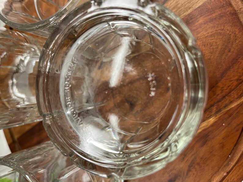 Puede incluir: Primer plano de un vaso de vidrio transparente para beber con una superficie texturizada. El vaso est&aacute; vac&iacute;o y parece nuevo.