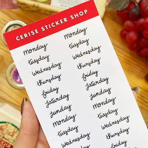 May include: A white sheet of paper with the words "CERISE STICKER SHOP" printed in red at the top. The sheet is filled with handwritten days of the week, each written in black cursive.