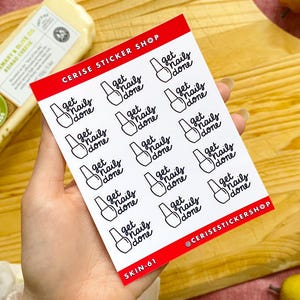 May include: A sheet of white stickers with a red border featuring the text "get nails done" and a nail polish bottle illustration in black. The sticker sheet also includes the text "CERISE STICKER SHOP" and "@CERISESTICKERSHOP".