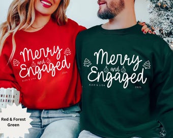 May include: Red and forest green sweatshirts with the text "Merry and Engaged" in white script. The design includes Christmas tree and ornament graphics, with the names "Alex & Lisa" and the year "2025" below the text. A festive holiday theme.