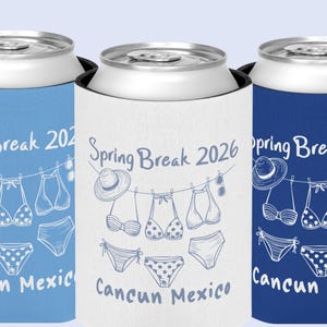 May include: Three can coolers in blue, white, and navy blue. Each cooler features the text "Spring Break 2026" and "Cancun Mexico" with a line drawing of a hat, sunglasses, and swimwear.
