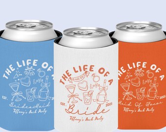 May include: Three beverage can coolers in blue, white, and orange. Each cooler features the text "THE LIFE OF A" with wedding-themed illustrations and the words "Bridesmaid", "Bride", or "Maid of Honor".