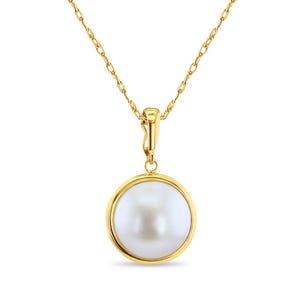May include: A gold-colored necklace featuring a large, round, white pearl pendant. The pearl is set in a gold bezel and hangs from a delicate gold chain. The necklace is displayed against a white background.