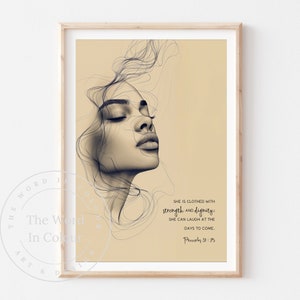 May include: A framed art print featuring a sepia-toned portrait of a woman with closed eyes, overlaid with delicate line art. The print includes the text "She is clothed with strength and dignity: she can laugh at the days to come. Proverbs 31:25."