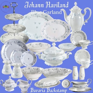 May include: A collection of white porcelain dinnerware with a blue floral pattern. The set includes plates, bowls, a teapot, a sugar bowl, a creamer, a butter dish, and salt and pepper shakers. The text "Johann Haviland Blue Garland Bavaria Backstamp" is visible in the image.