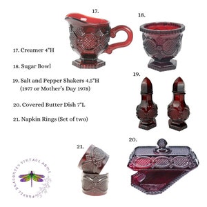 May include: Set of red glass kitchenware items, including a creamer, sugar bowl, salt and pepper shakers, a covered butter dish, and napkin rings. All items are decorated with a raised pattern.
