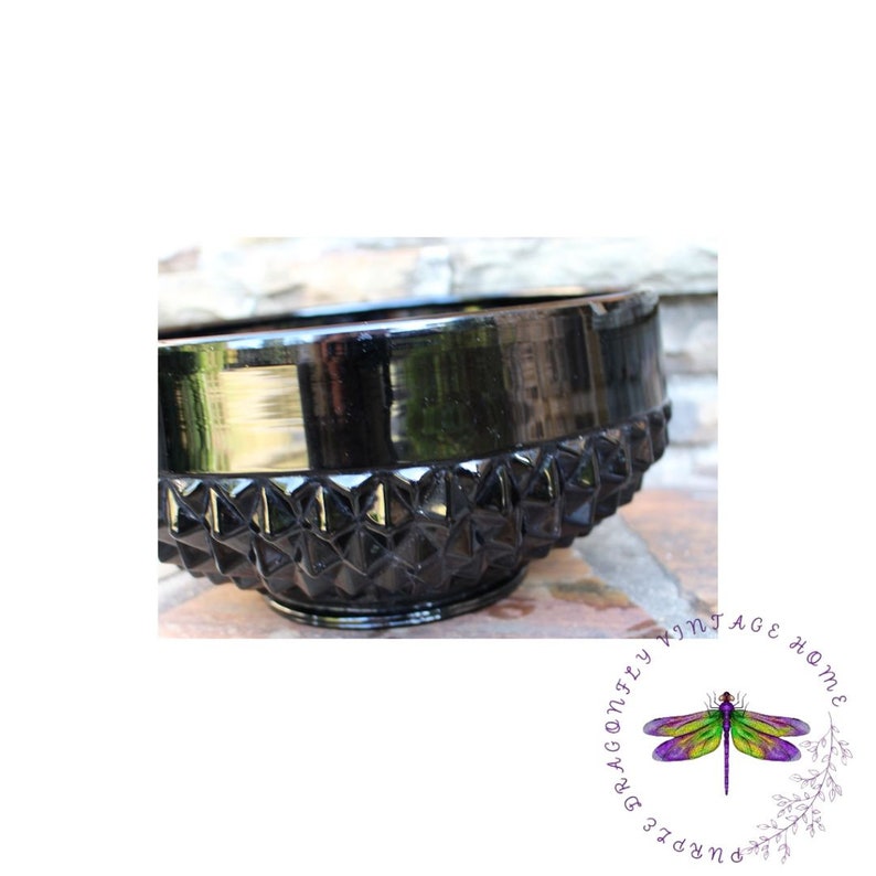 K&ouml;nnte beinhalten: Eine schwarze Glassch&uuml;ssel mit einem rautenf&ouml;rmigen Muster. Die Sch&uuml;ssel ist gl&auml;nzend und hat einen glatten, abgerundeten Rand.