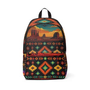 May include: A backpack featuring a desert landscape illustration with rock formations under a sunset sky on the upper section, and a black base decorated with a repeating geometric pattern in orange, yellow, teal, and red across the front pocket.