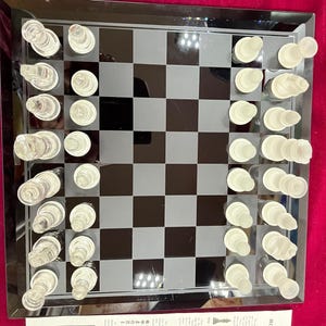 Handsome vintage glass chess set. The chess board has a lovely beveled edge .