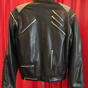 Rare find.  Vintage &quot;Michael Jackson Beat It Black Leather Jacket&quot; with multiple zippers and mesh wire on shoulders with detachable sleeves.