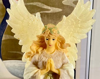 Vintage praying winged angel figurine  in a pink robe.