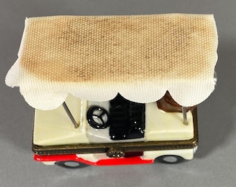 Vintage porcelain hinged golf cart with golf club trinket box. Included is an extra golf club and a golf ball .