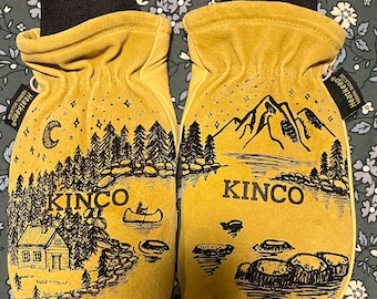 May include: A pair of yellow leather mittens with black cuffs. Each mitten features a black and white illustration of a lakeside cabin and mountains with the word "KINCO". The mittens are labeled "Heatkeep".