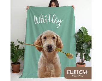 May include: A rectangular sage green fleece blanket featuring a large, centred photographic print of a golden-coloured dog holding a yellow tulip in its mouth. Above the dog, the name Whitley is printed in white script with a small heart icon.