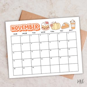 May include: A November calendar page featuring a grid with thirty numbered days. The header displays the word NOVEMBER in orange, accompanied by illustrations of a donut, a pumpkin, a slice of pie, and a coffee cup with a smiling face.