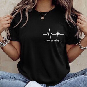 Still Beating Motivational Tshirt Inspirational Shirt Positive Tee Mental Health Tshirt Self Improvement Tee Think Positive Teacher Shirt