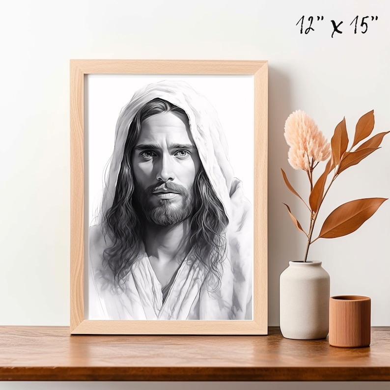 May include: Black and white drawing of Jesus Christ with long hair and a beard, wearing a white robe with a hood. The drawing is framed in a light wood frame.